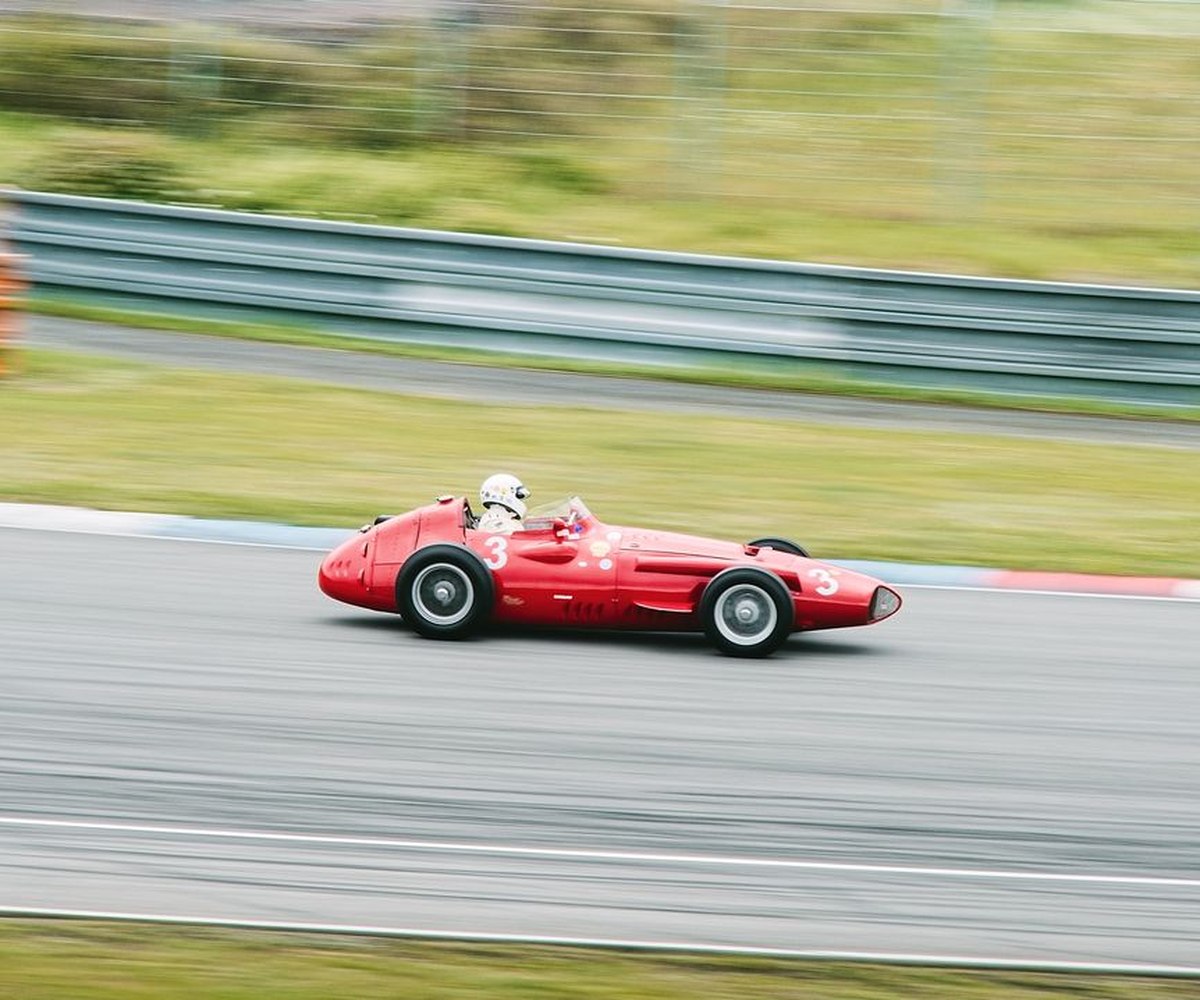 A vintage single-seater race car speeding around a track