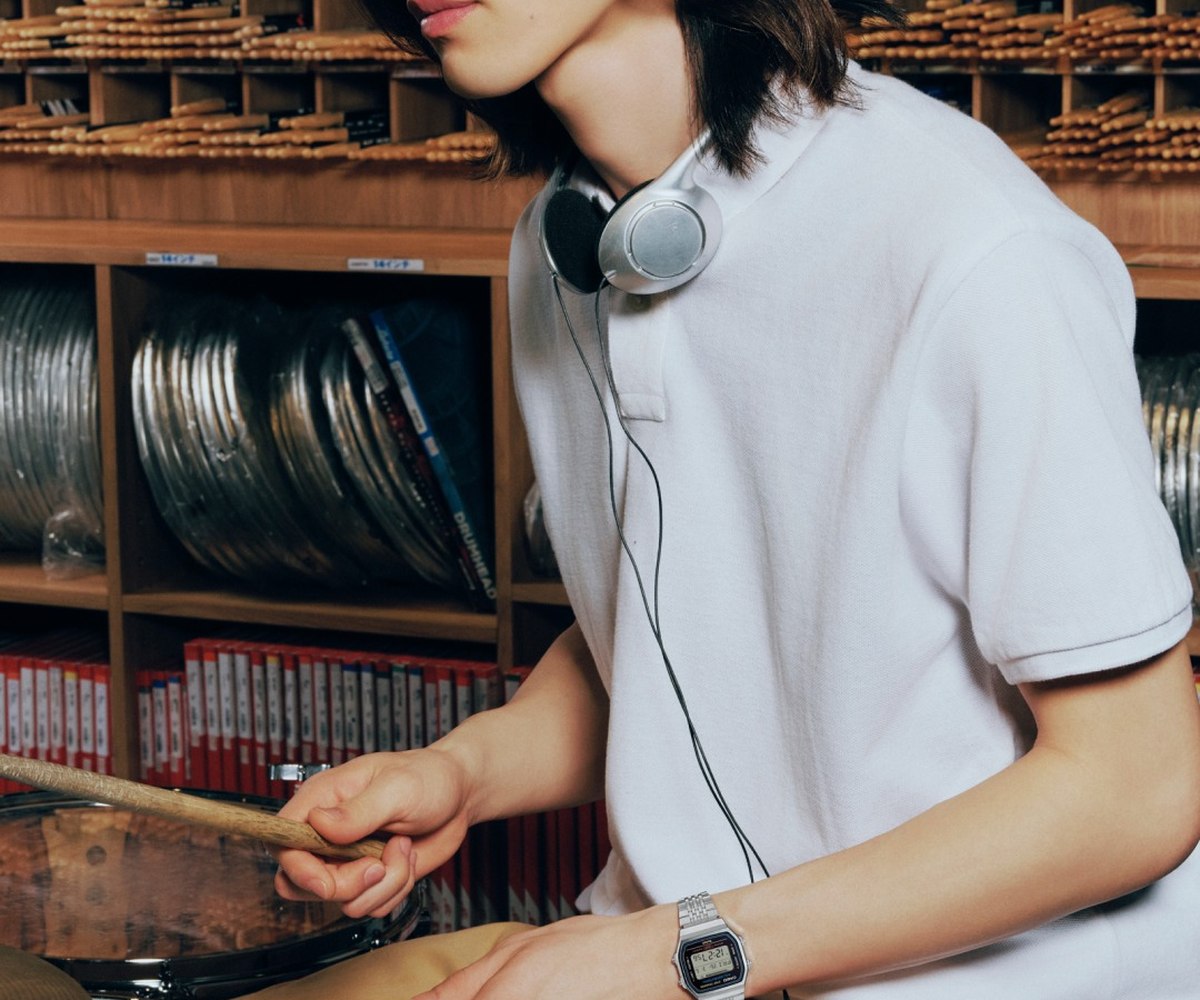 A black Casio watch worn on the wrist in a record store