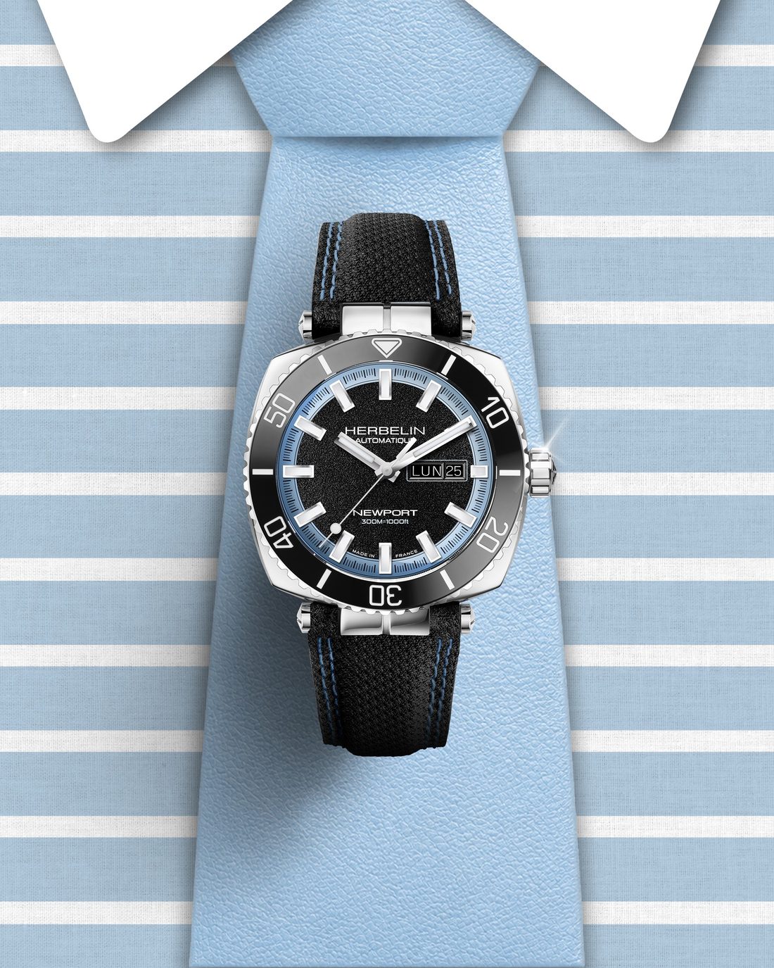 Montre de plongee Michel Herbelin Newport posee sur une cravate rayee bleue et blanche