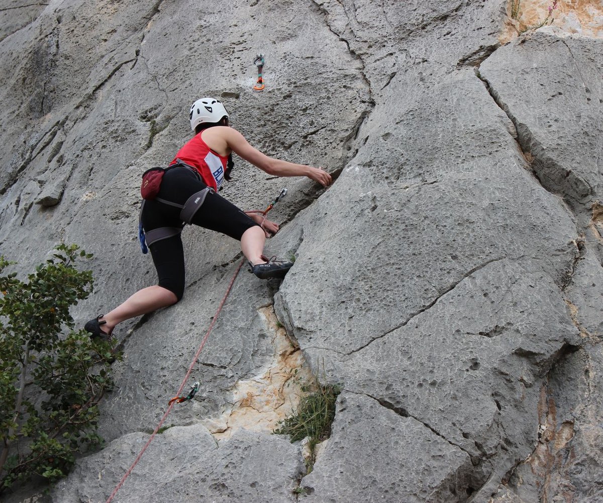 Grimpeur sur une paroi rocheuse claire