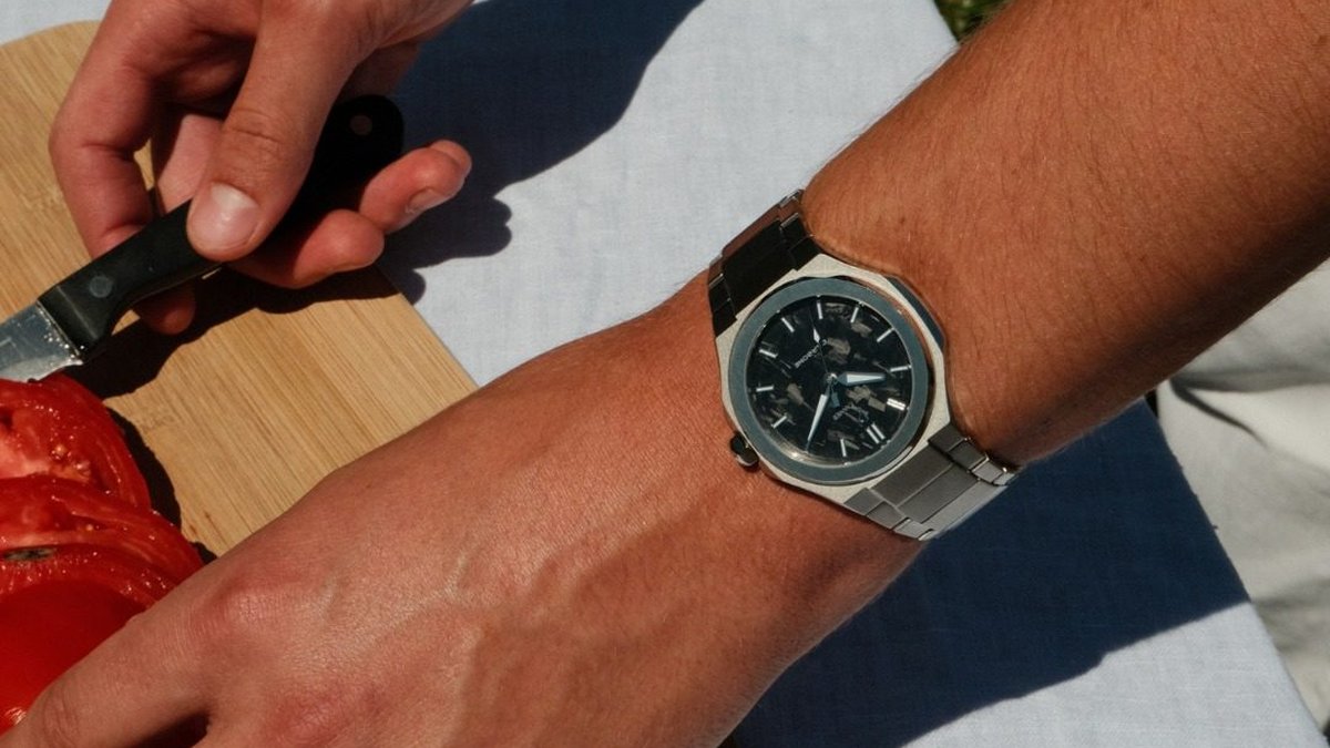 A French watch on her wrist during an outdoor summer lunch